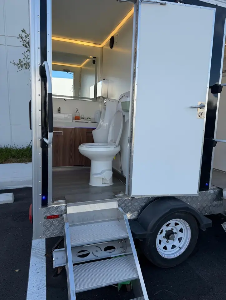 Luxury restroom trailer interior with warm lighting