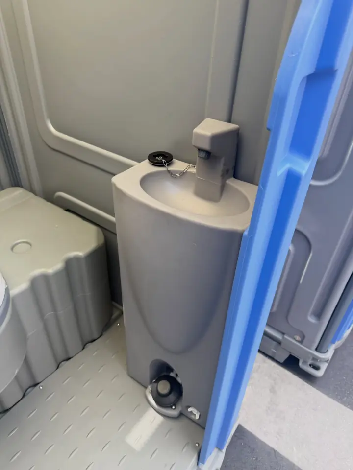 Foot-pump sink inside a portable restroom