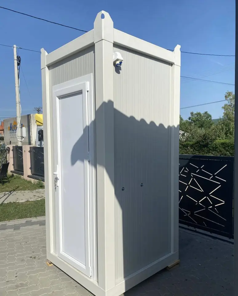 White VIP restroom cabin standing on pavement